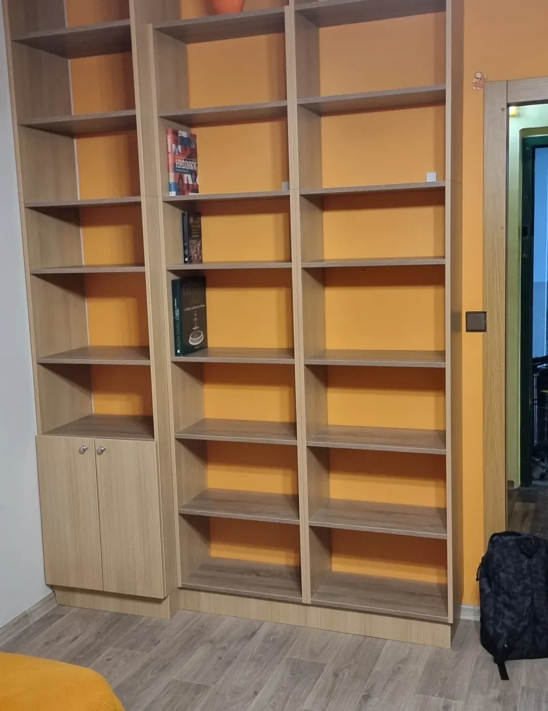 Vysoká světlá knihovna s&nbsp;rovnými policemi od podlahy ke stropu